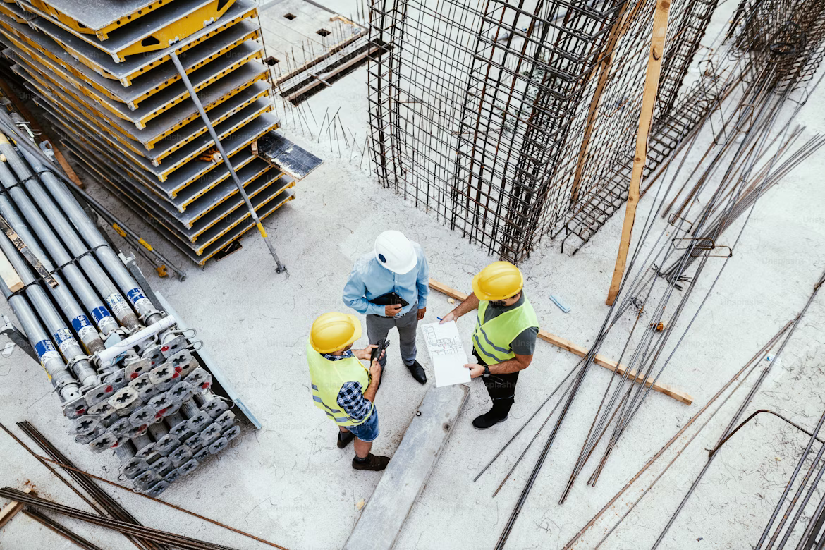 Construction engineers discussing building work on site